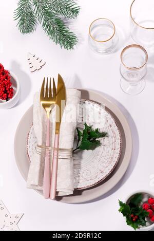 Winter festive table setting with cutlery on table. Christmas tableware. Stock Photo