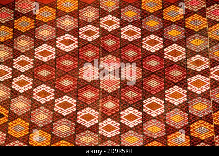 Turkish carpet with pattern has a red ornament and woven by the craftsmen of Cappadocia. Stock Photo