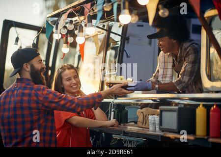 group of young multiethnic people having fun at fast food service Stock Photo
