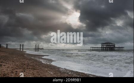 Brighton's stoney beach landscape and West Pier ruins, England Stock Photo