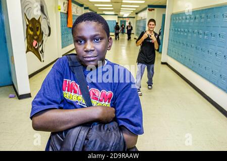 Miami Florida,Homestead Campbell Drive Middle School,student students Hispanic Black African teen teenager boy,hall hallway, Stock Photo