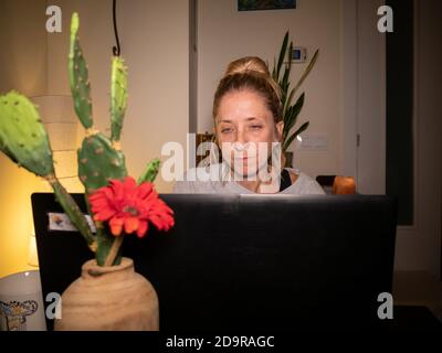 Closeup of an exhausted and stressed woman working from home on her laptop Stock Photo