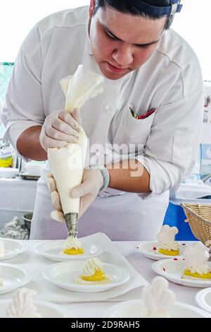 Miami Beach Florida,Wine & Food Festival,annual event tasting sampling celebrity chefs gourmet foods free samples,baker chef preparing dessert using p Stock Photo