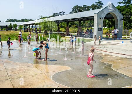 Louisiana Northshore,Mandeville,kids children boys girls play playing interactive ground spray fountain,near Tammany Trace, Stock Photo