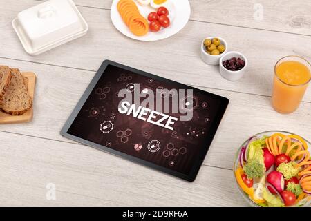 Healthy Tablet Pc compostion with SNEEZE inscription, immune system boost concept Stock Photo