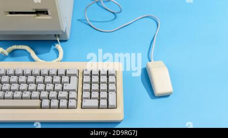 personal computer with keyboard and mouse. old desktop computer on a blue background Stock Photo