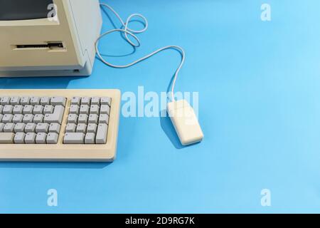 personal computer with keyboard and mouse. old desktop computer on a blue background Stock Photo