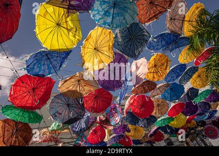 Colored umbrellas suspended in the air in higuey Stock Photo