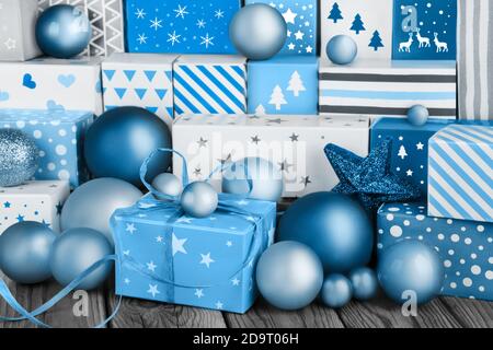 Blue Christmas gifts and ornaments on wooden background Stock Photo