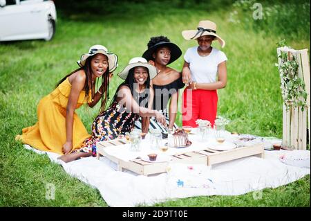 Group of african american girls celebrating birthday party and cutting cake outdoor with decor. Stock Photo