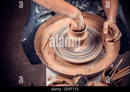 Close-up of potter's hands with the product on a potter's wheel Stock Photo