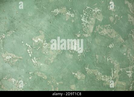 Concrete green khaki background with scuffs and splashes. Textured wall texture in the grunge style with soft focus. Space for text Stock Photo