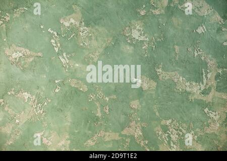 Concrete green khaki background with scuffs and splashes. Textured wall texture in the grunge style with soft focus. Space for text Stock Photo