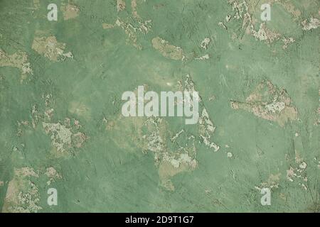 Concrete green khaki background with scuffs and splashes. Textured wall texture in the grunge style with soft focus. Space for text Stock Photo