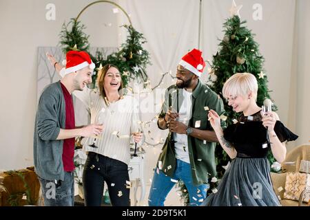 corporate party happy friends dancing with confetti and champagne Stock Photo