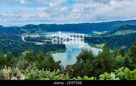 Sete Cidades on Sao Miguel is a small town in a volcanic crater with a big crater lake Stock Photo