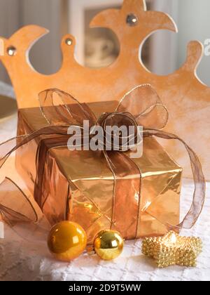 Gift box with gold coloured wrapping paper and a black ribbon and bow Stock  Photo - Alamy