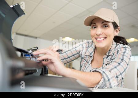 happy female fixing the printer Stock Photo