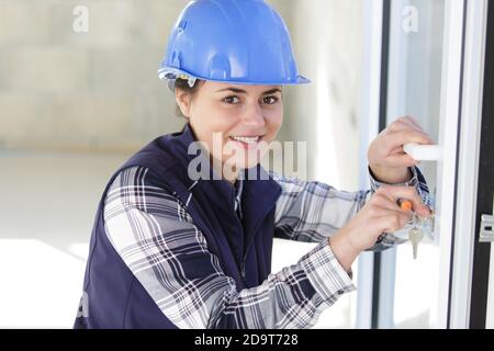 woman using a screw driver for installing door Stock Photo