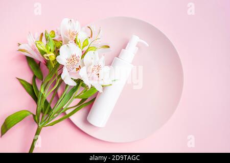 Cosmetic bottle with dispenser with bouquet Stock Photo