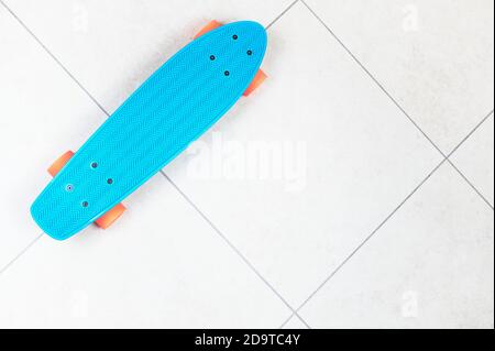 Skateboard cruiser style blue yellow and orange view from above Stock Photo