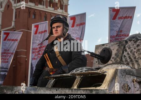 Moscow, Russia. 7th of November, 2020 Red Army's soldier in uniform of the beginning the World War II on an FAI-M armored car against the background of the Spasskaya tower on the Red Square in Moscow, Russia. The exhibition on the Red Square features military hardware and installations depict scene of daily life in Moscow during WWII, the mobilisation and the work done by Muscovites to defend the Russian capital, and scenes of WWII battles that took place near Moscow Stock Photo