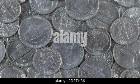 Close shot mass of U.S. nickels and dimes coins. For cheap, low-paying job, low-cost, penny-pinch, five and dime store, being frugal. 16:9 format. Stock Photo