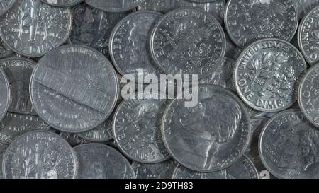 Close shot mass of U.S. nickels and dimes coins. For cheap, low-paying job, low-cost, penny-pinch, five and dime store, being frugal. 16:9 format. Stock Photo
