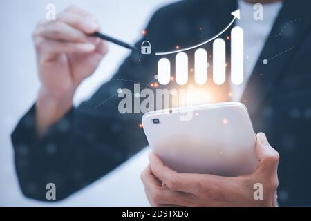 Businessman hold the tablet on blue background dark polygon digital network with using line flying globe social interaction concept. Stock Photo