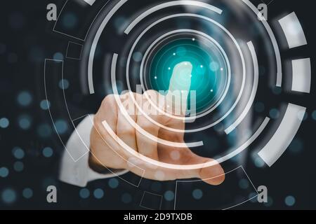 Young businessmen use finger choose to press icons on blue background dark polygon digital network with using line flying globe social interaction con Stock Photo