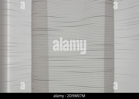 gray beige tulle curtain folds, transparent textile mesh texture Stock Photo