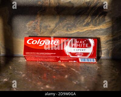 Paris, France - Nov 6, 2020: Package of Colgate max White expert on the natural stone background Stock Photo