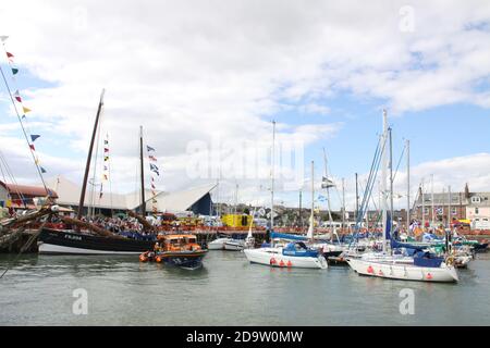 The Reaper, an old preserved Fifie Scottish wooden fishing boat, with many other boats at a festival in Arbroath Harbour, Scotland Stock Photo