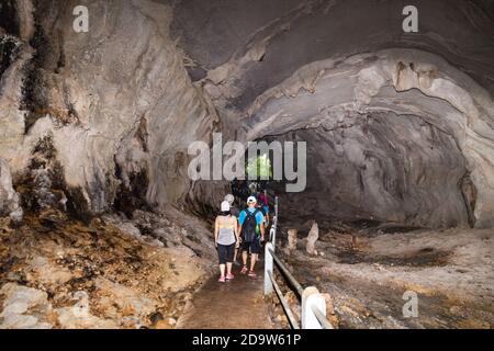 Tourists walking within path inside Wind Cave, Mulu National Park Stock Photo