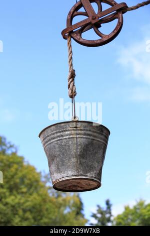 Well pulley and bucket at the zoo Stock Photo