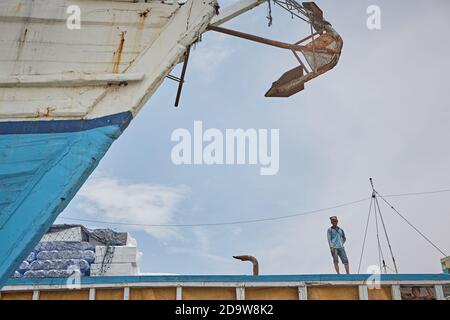 Jakarta, Indonesia, March 2016. Sailors working on the traditional wooden boats, the Pinisi, in the port of Sunda Kelapa. Stock Photo