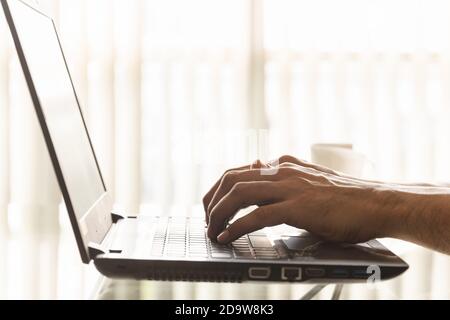 Close-up hands of businessmen are using laptops in the office. Stock Photo