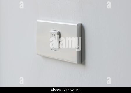 Closeup a white switch for on and off wall lighting for office and residential. Stock Photo