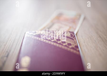 Sweden Passport with Fifty Burmese Kyats Bill Partially Inside Stock Photo