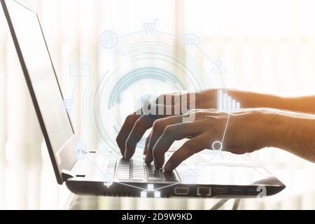 Closeup hands of businessmen are using laptops in the office with connection icon graphic screen. Stock Photo