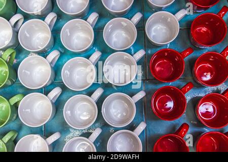 Colorful ceramic glass mug in different shape and form. Top view Stock Photo