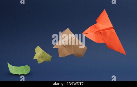 Transformation from caterpillar to butterfly, analog to digitalization, business concept in paper folding Stock Photo