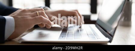 Close up wide banner image young businessman using computer. Stock Photo