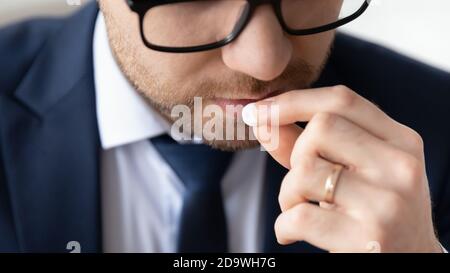 Young male manager employee in formal wear taking painkiller. Stock Photo