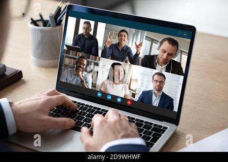 Happy multiracial colleagues holding online video conference call. Stock Photo