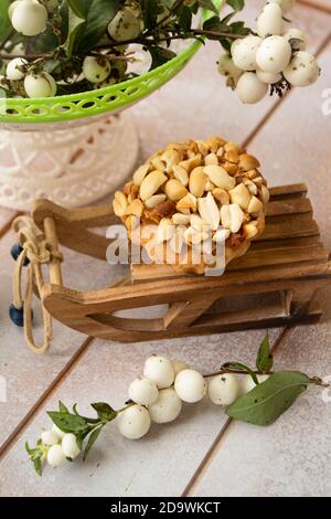 delicious peanut muffins, winter decoration on white wooden table Stock Photo