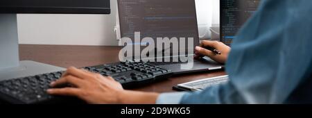 Software developer or programmer working data debugging improvement binary algorithm on desktop pc in a software develop company office Stock Photo