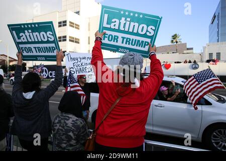 Beverly Hills, United States. 07th Nov, 2020. Two Trump supporters hold placards saying 'Latinos for Trump' during the rally.Despite an election victory for Joe Biden and Kamala Harris, supporters of President Trump congregated at Beverly Gardens Park in Beverly Hills, California to demand justice for what they claimed was a rigged election and rallied behind the idea of four more years of Donald Trump as president. Credit: SOPA Images Limited/Alamy Live News Stock Photo