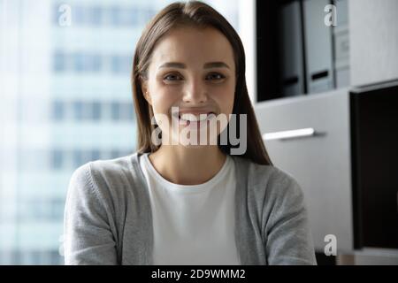 Portrait of confident lady employee taking part in briefing online Stock Photo