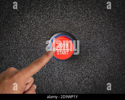 Close up on finger pressing button with numbers showing start to New Year 2019. Stock Photo
